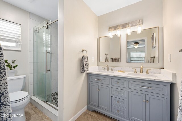 bathroom featuring tile patterned flooring, vanity, toilet, and walk in shower