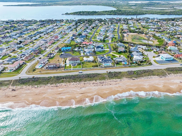 aerial view with a water view and a view of the beach