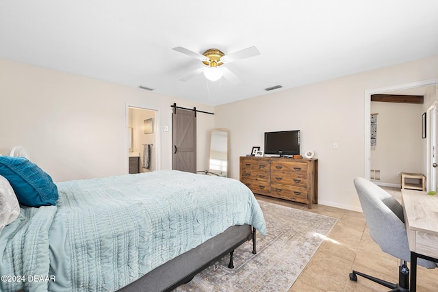 tiled bedroom featuring ceiling fan, a barn door, and connected bathroom