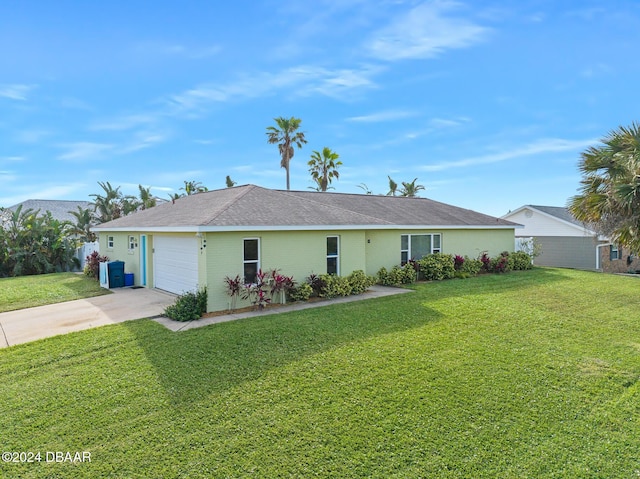 ranch-style home with a garage and a front lawn