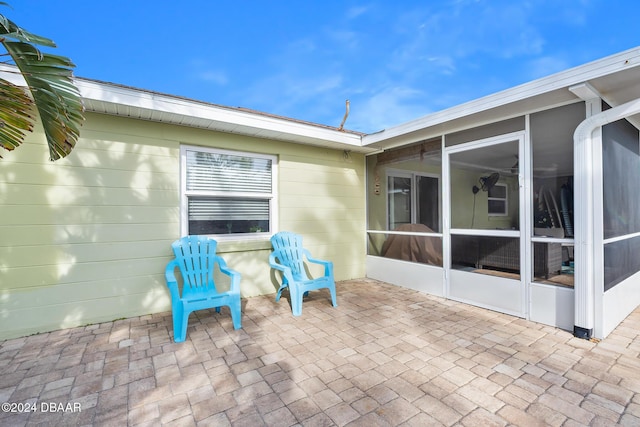 view of patio featuring a sunroom