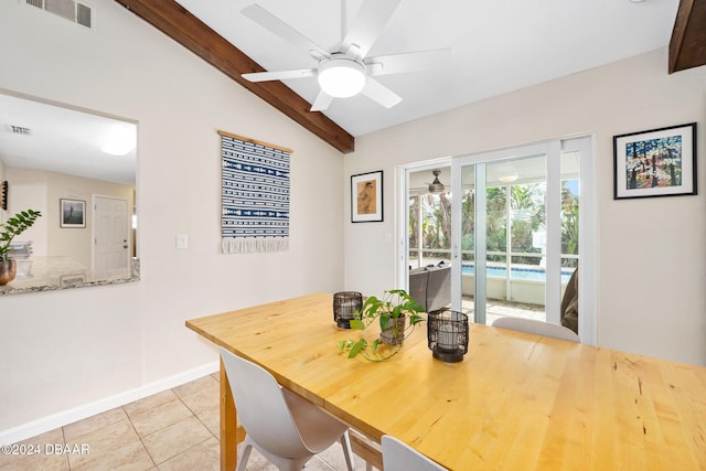 tiled dining space featuring ceiling fan and vaulted ceiling