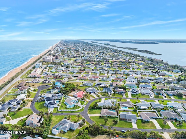 birds eye view of property with a water view and a view of the beach