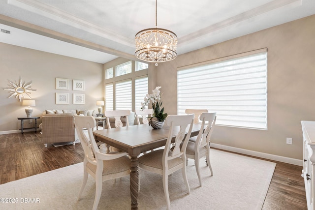 dining space featuring dark hardwood / wood-style flooring and a notable chandelier