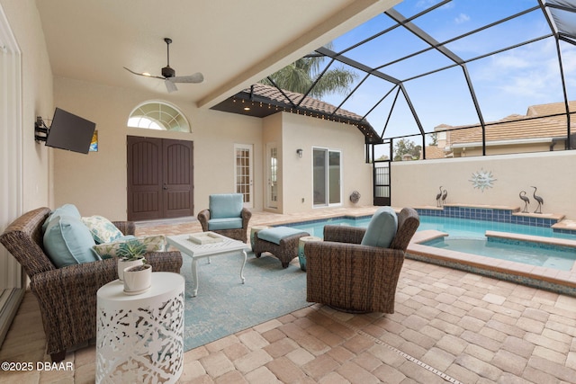 view of patio featuring ceiling fan, a lanai, outdoor lounge area, and a swimming pool with hot tub