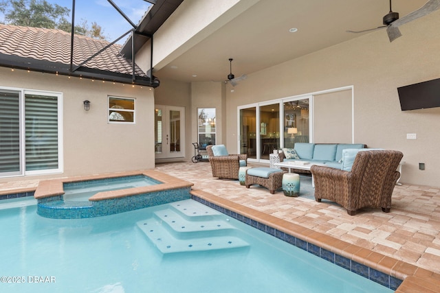 view of swimming pool featuring a patio area, an in ground hot tub, ceiling fan, an outdoor living space, and glass enclosure