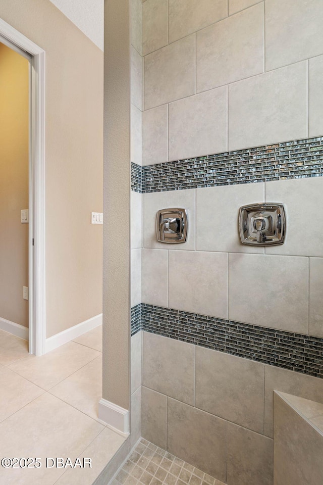 bathroom featuring tile patterned floors and a tile shower