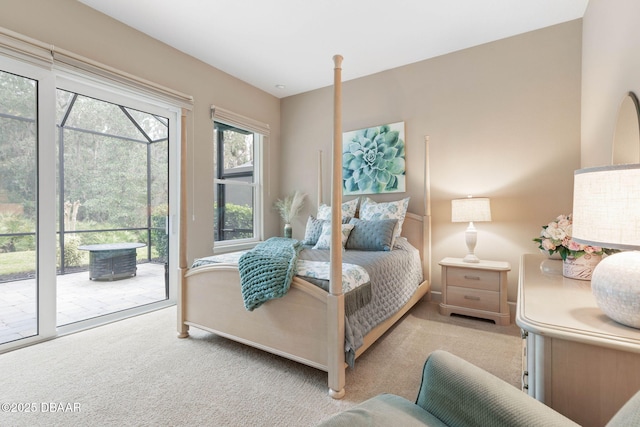 bedroom with access to outside and light colored carpet