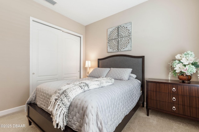 bedroom with light carpet and a closet