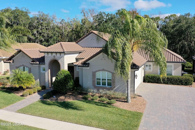 mediterranean / spanish-style home with a front yard