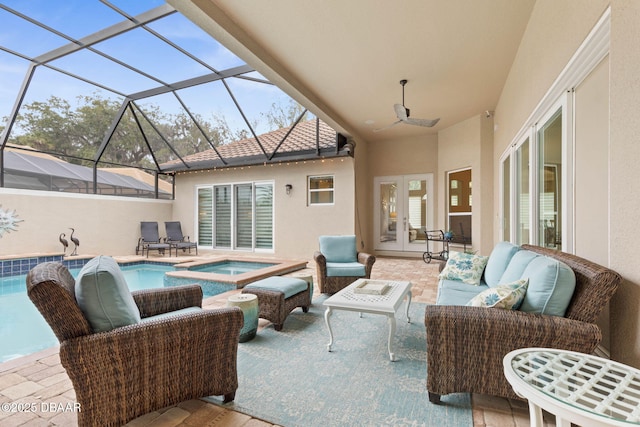 view of patio / terrace with french doors, a lanai, an outdoor hangout area, and a pool with hot tub