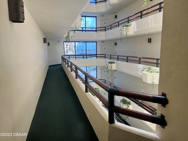 corridor featuring a towering ceiling