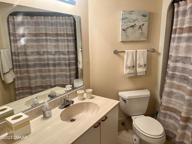 bathroom with vanity, a shower with shower curtain, tile patterned flooring, and toilet