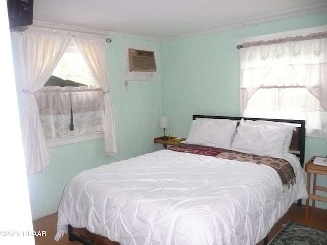 bedroom with ornamental molding and a wall mounted AC