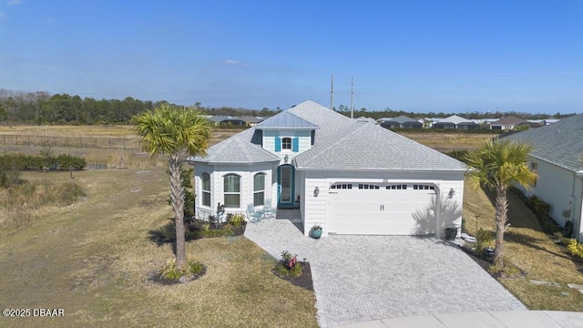 view of front of property featuring a garage and a front lawn