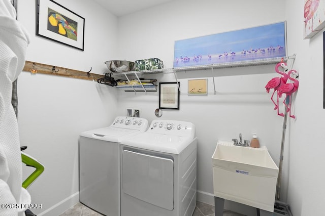 laundry room with separate washer and dryer and sink