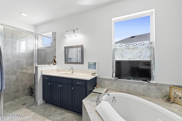 bathroom featuring tile patterned flooring, vanity, and shower with separate bathtub