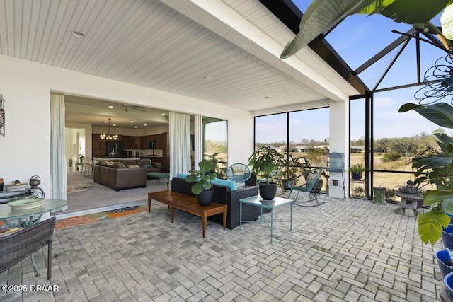 sunroom / solarium featuring an inviting chandelier