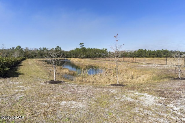 view of yard with a water view and a rural view