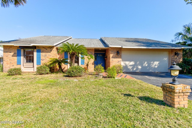 ranch-style house featuring a garage and a front lawn