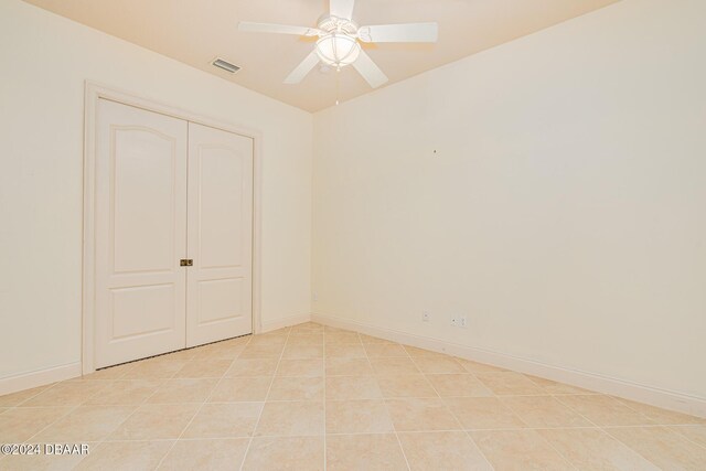 540 Leeway Trl, Ormond Beach, FL 32174 - unfurnished bedroom featuring a ceiling fan, a closet, and light tile patterned floors