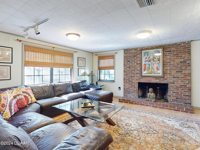 tiled living room with a fireplace and track lighting