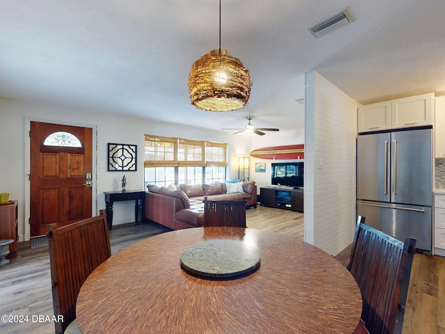 dining room with light hardwood / wood-style flooring and ceiling fan