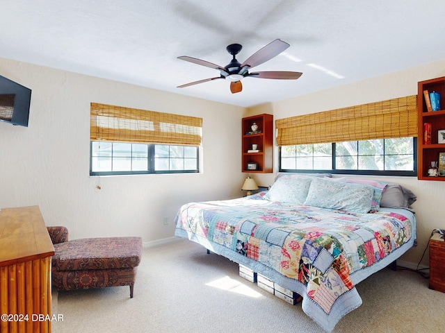 bedroom featuring carpet, multiple windows, and ceiling fan