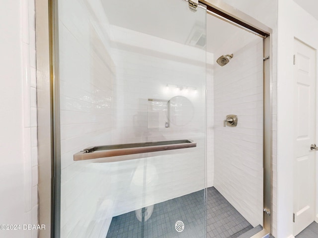 bathroom featuring a shower with door