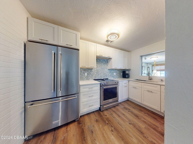 kitchen featuring white cabinets, stainless steel appliances, dark hardwood / wood-style floors, and sink