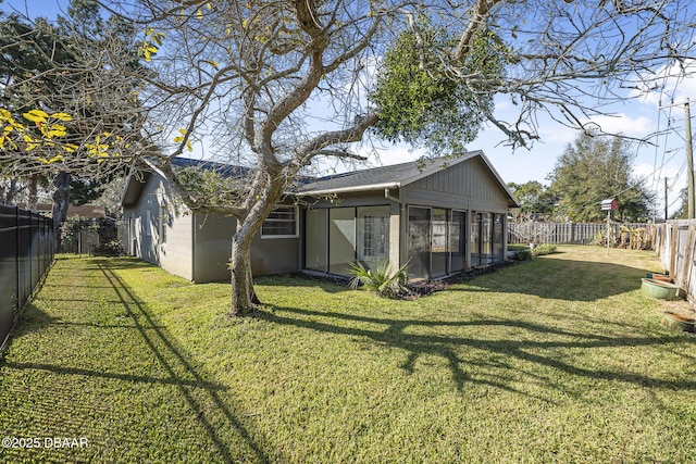 exterior space featuring a sunroom and a yard