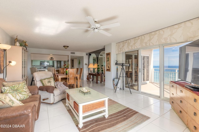 living room featuring ceiling fan and light tile patterned floors