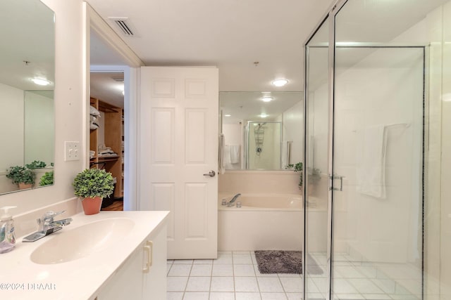 bathroom with shower with separate bathtub, tile patterned floors, and vanity