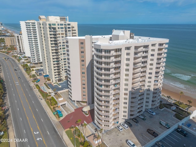 birds eye view of property with a view of the beach and a water view