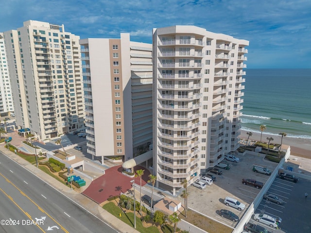 view of property featuring a water view and a beach view