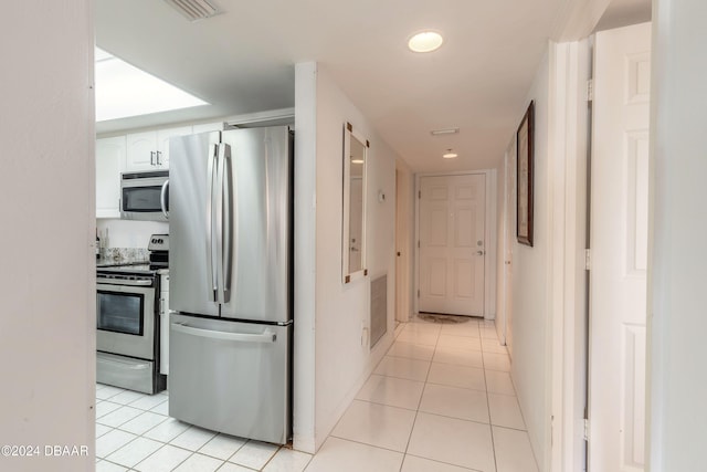 hallway featuring light tile patterned floors