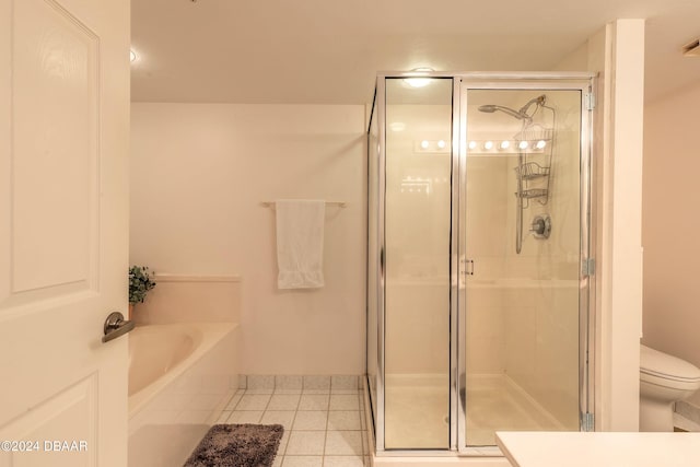 bathroom with tile patterned floors, toilet, and plus walk in shower