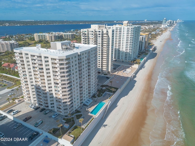 birds eye view of property with a water view and a view of the beach