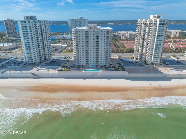 drone / aerial view with a water view and a beach view