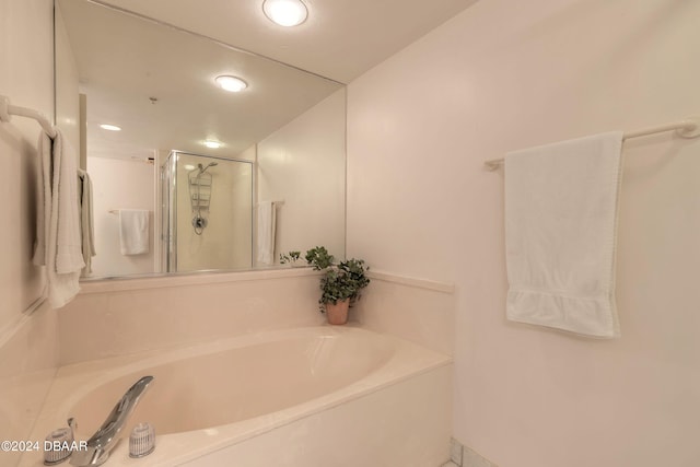 bathroom featuring separate shower and tub