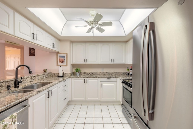 kitchen with white cabinets, appliances with stainless steel finishes, and sink