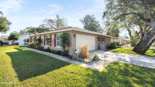 view of front facade featuring cooling unit, a garage, and a front lawn