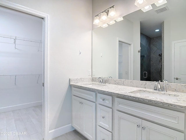 bathroom featuring vanity and a shower with shower door