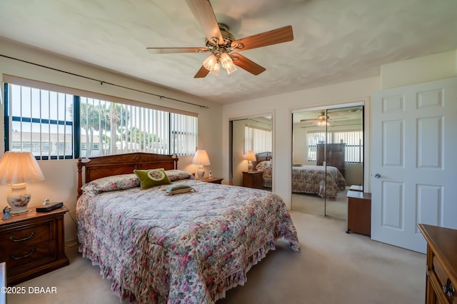 45 Harvard Dr, Ormond Beach, FL 32176 - bedroom featuring multiple windows, two closets, a ceiling fan, and light carpet