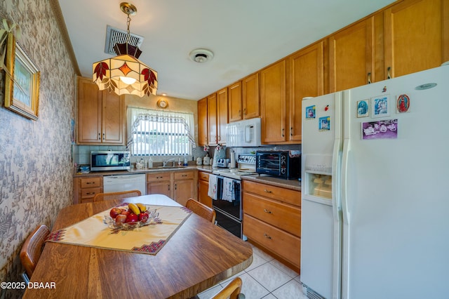 45 Harvard Dr, Ormond Beach, FL 32176 - kitchen with a sink, wallpapered walls, white appliances, a toaster, and visible vents