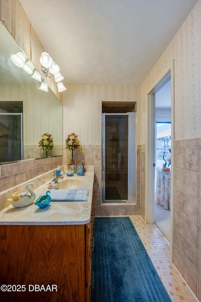 45 Harvard Dr, Ormond Beach, FL 32176 - full bath with tile walls, wallpapered walls, a wainscoted wall, and a shower stall