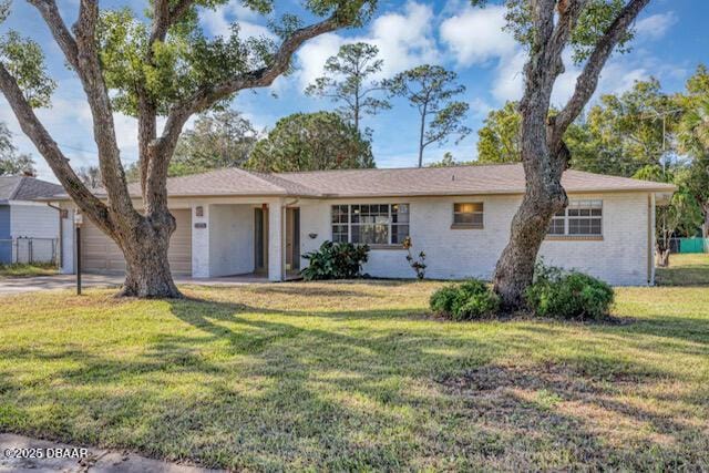 ranch-style home with a garage and a front yard