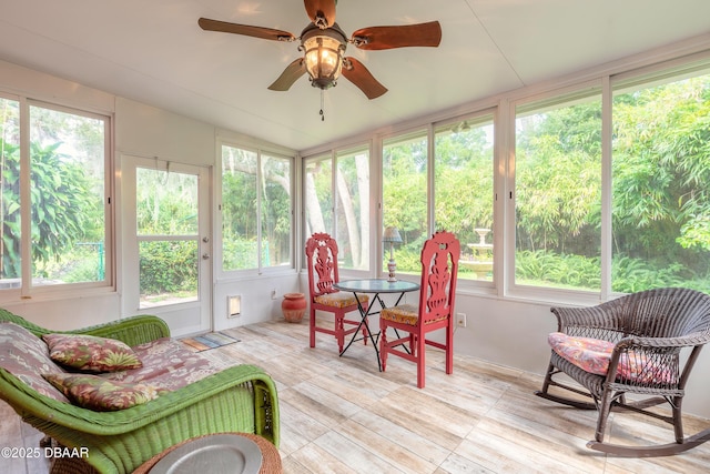 sunroom / solarium with vaulted ceiling and a ceiling fan