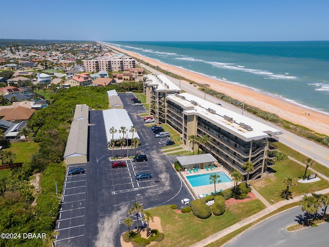 bird's eye view with a water view and a beach view