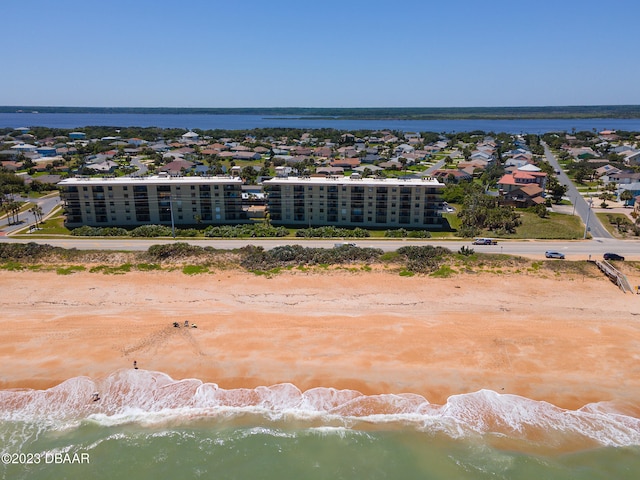 birds eye view of property with a view of the beach and a water view